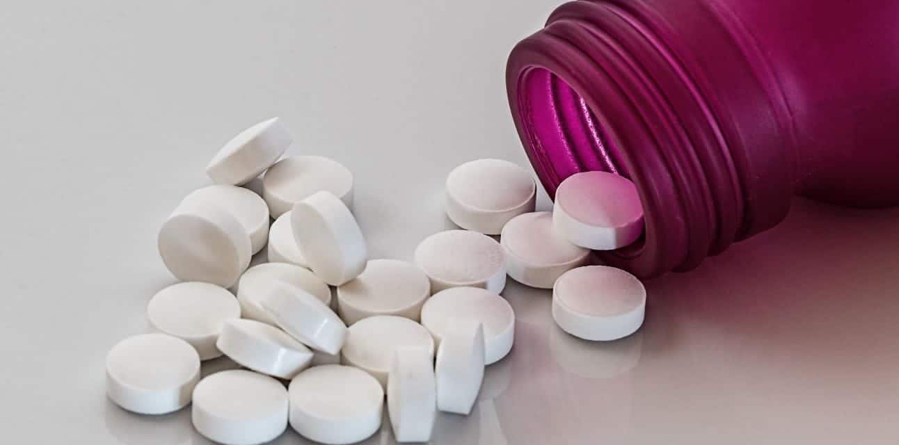 Pill Tablets Pills out of bottle on table