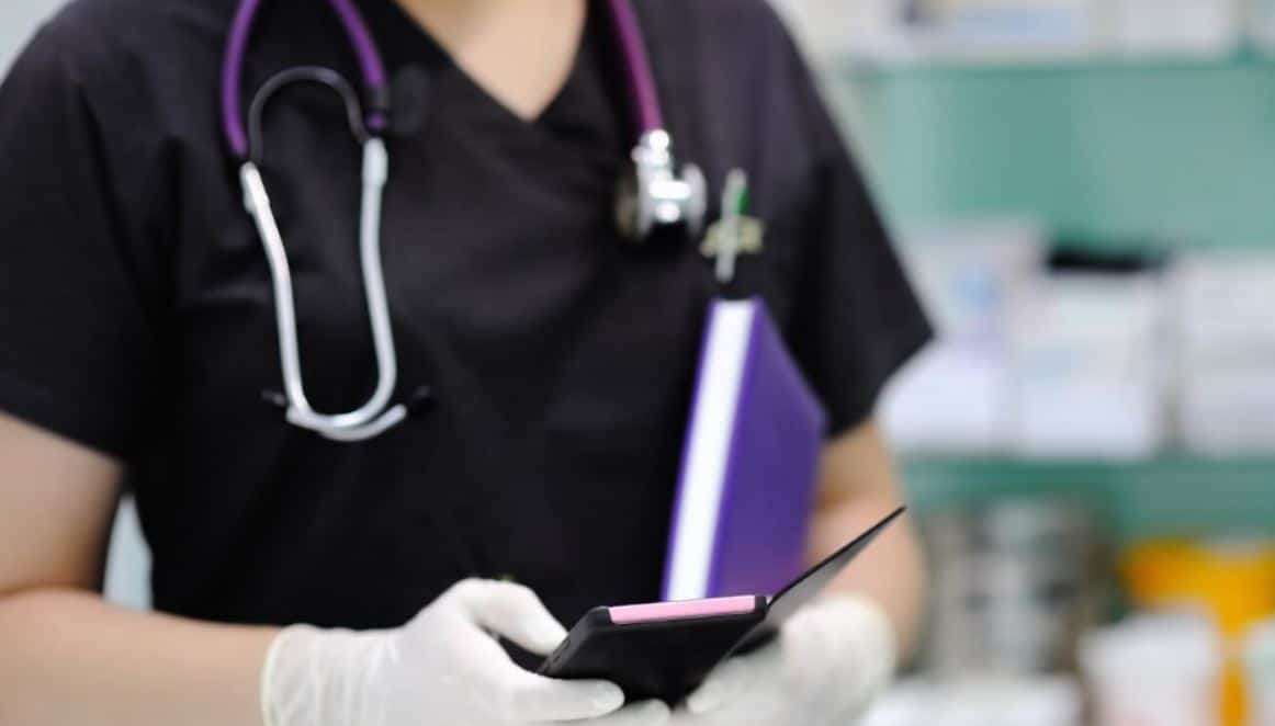 Vet Tech Smartphone Vet tech searching on her smartphone